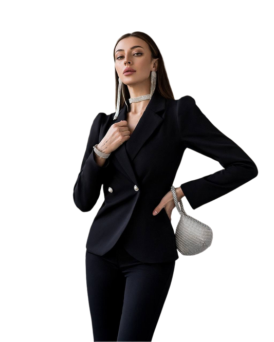 Woman in a black suit holding a silver handbag on a white background
