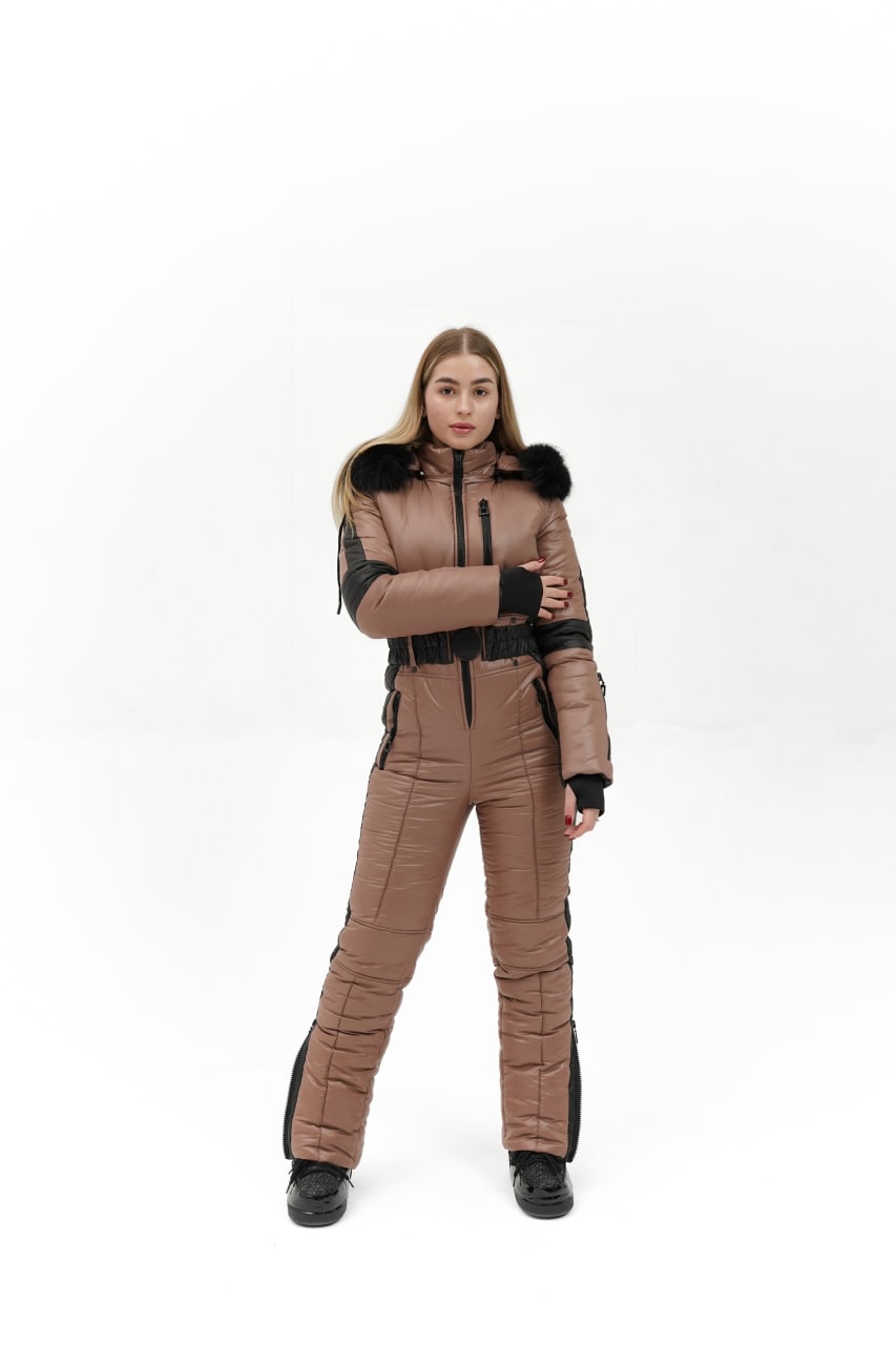 Person wearing a brown and black snowsuit on a white background