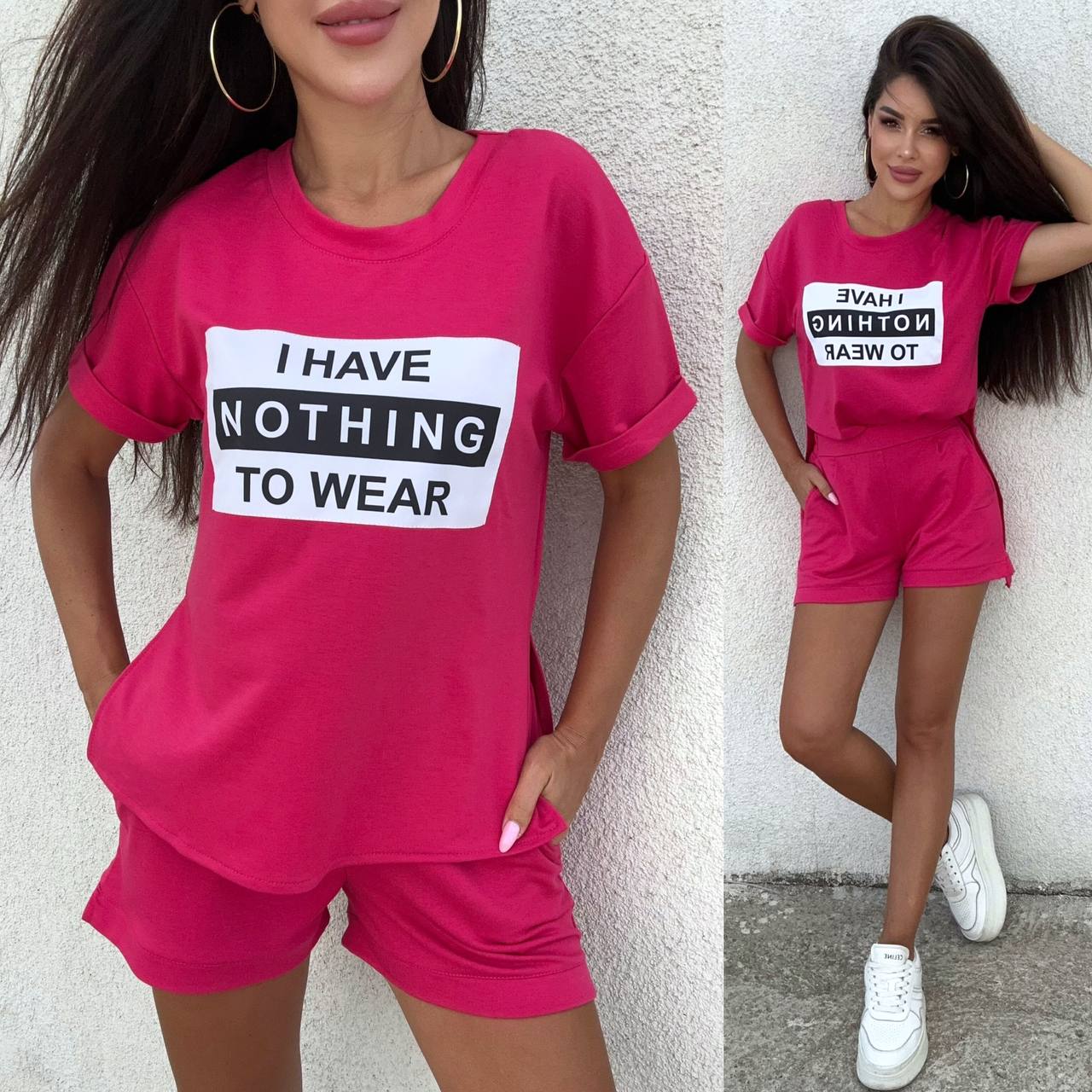 Woman wearing a pink outfit with a 'I HAVE NOTHING TO WEAR' t-shirt against a light gray wall.