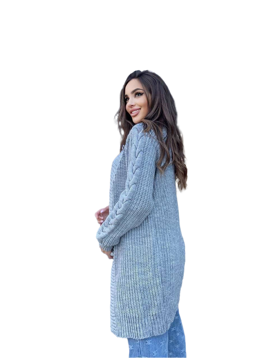 Woman wearing a long, light blue knitted cardigan on a white background