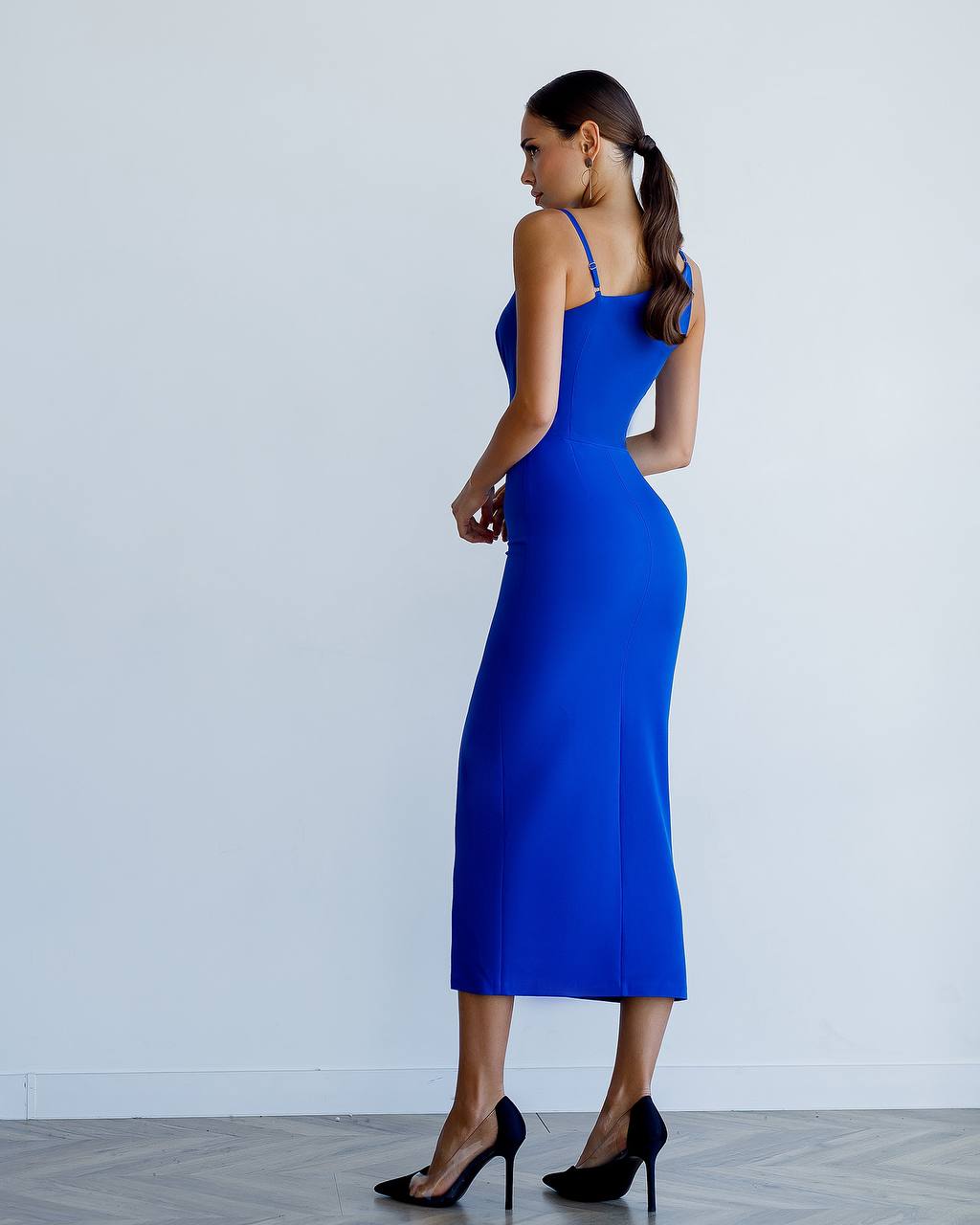 Woman wearing a blue dress with a white background