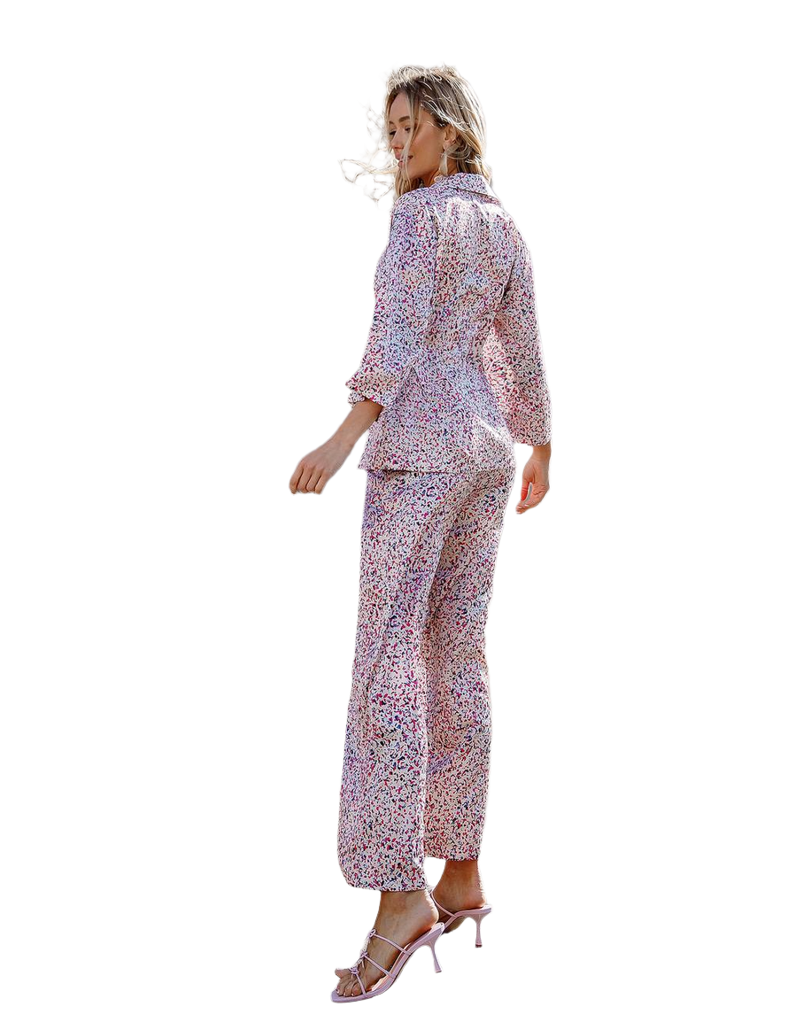 Woman wearing a floral pajama set on a white background