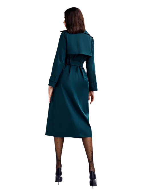 Woman wearing a teal dress with a belt on a white background