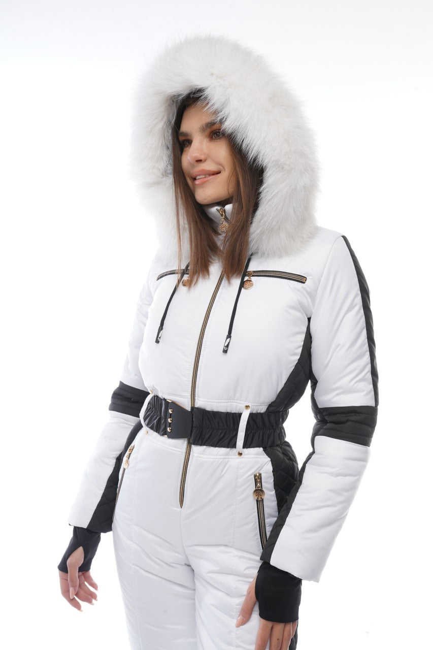 Woman wearing a white winter suit with a fur-lined hood on a white background