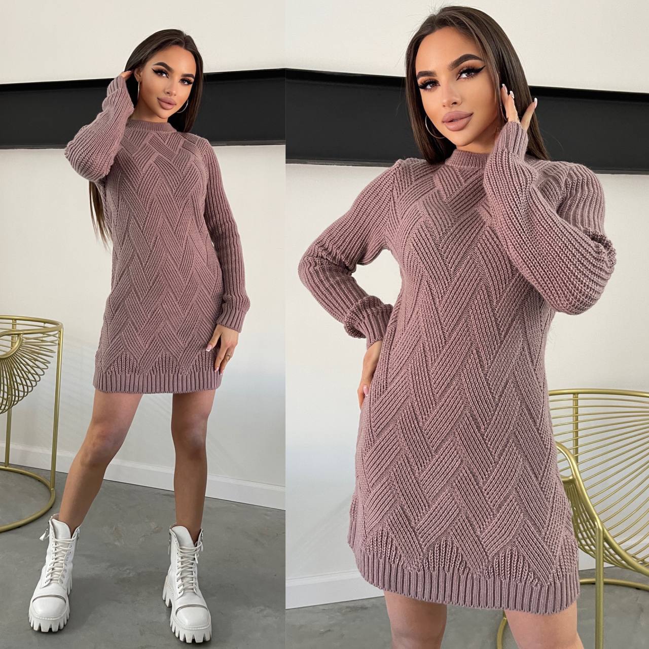 Woman wearing a pink knitted dress with white sneakers in a minimal indoor setting.