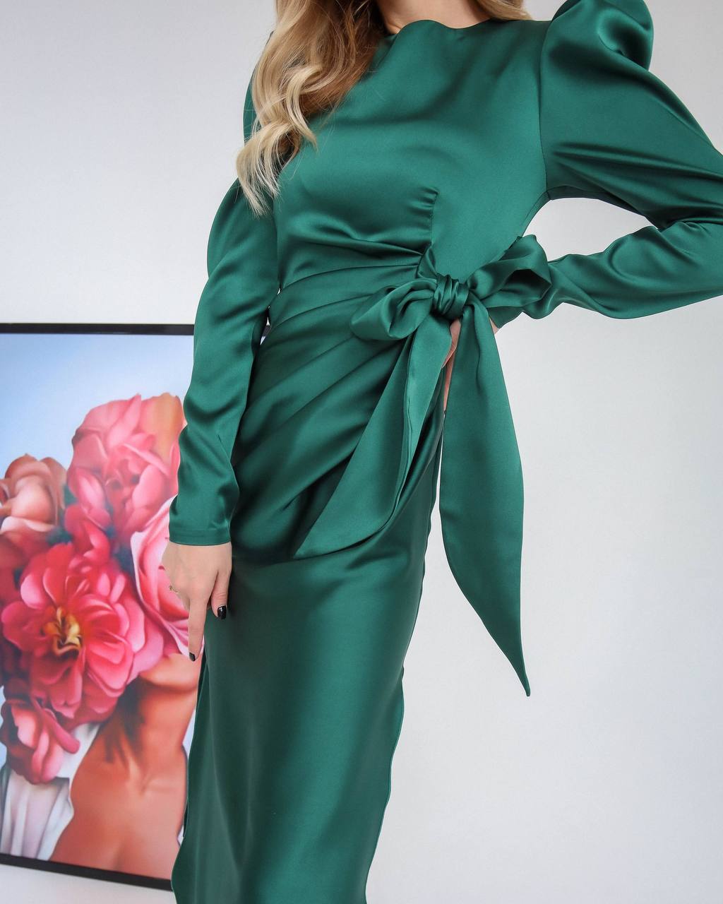 Green dress with a bow detail on a white background