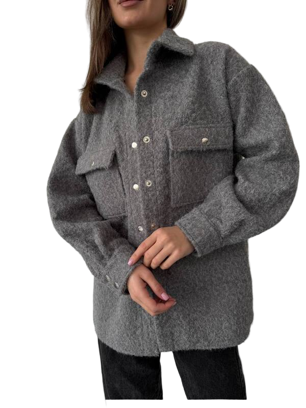 Person wearing a gray coat with button details on a white background
