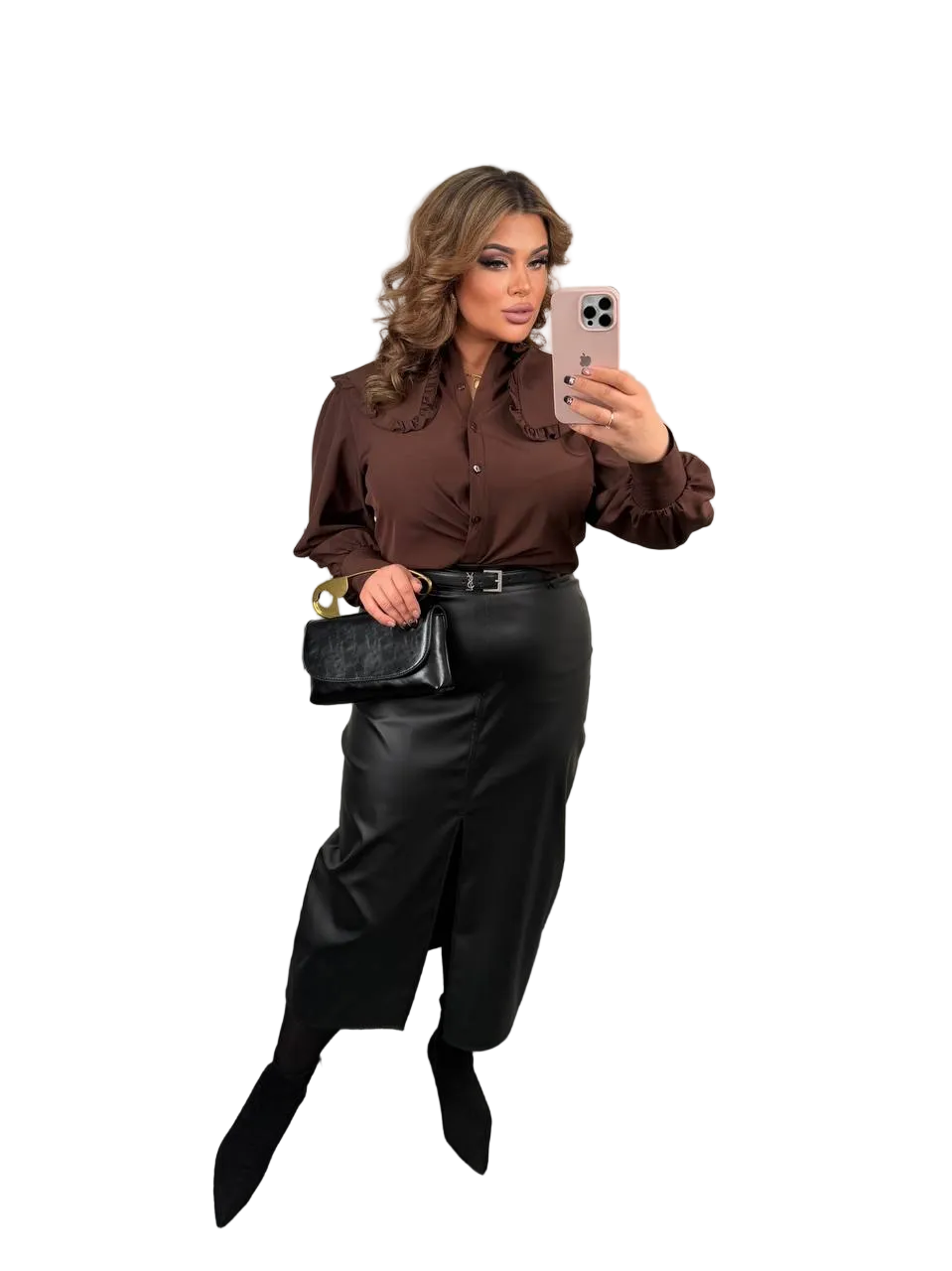 Woman taking a selfie wearing a brown blouse and black pants on a white background
