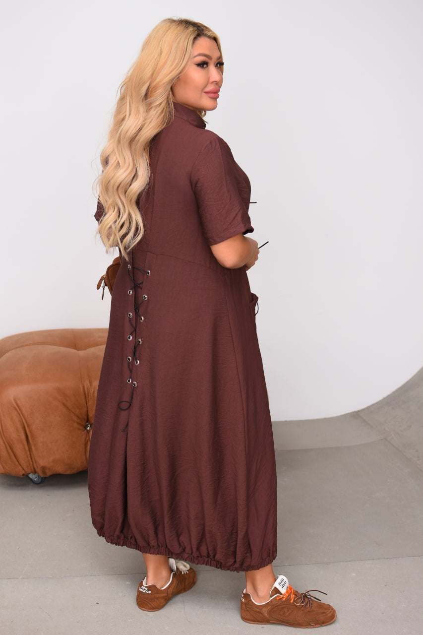 Woman wearing a brown dress with a white background