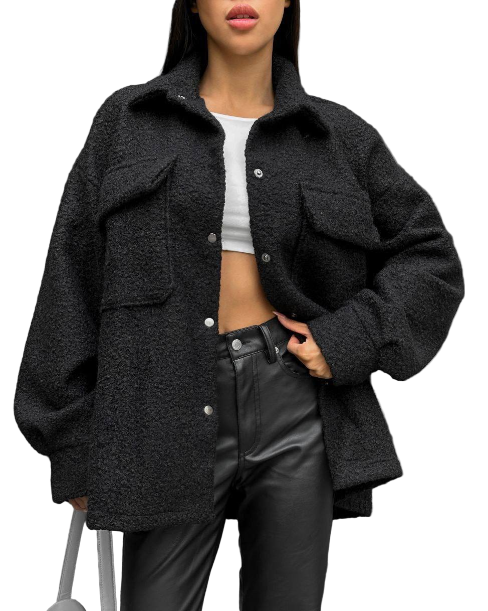 Person wearing a black oversized jacket with a white background