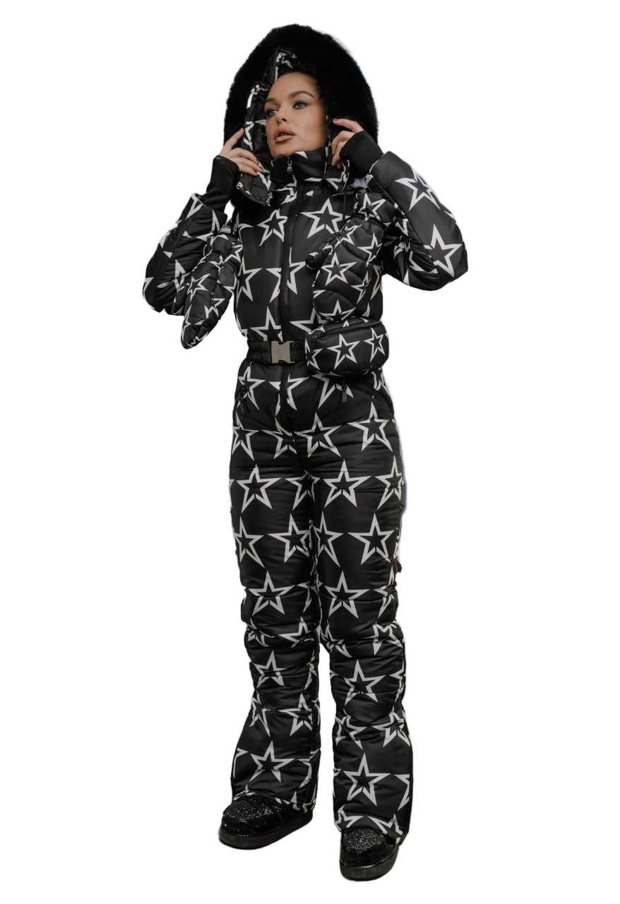 Person wearing a black snowsuit with star patterns on a white background