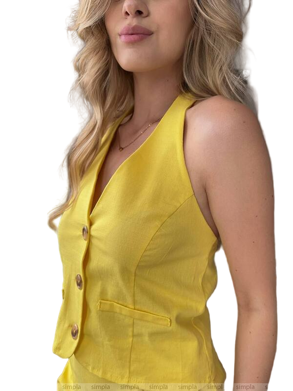 Yellow sleeveless top worn by a person on a white background
