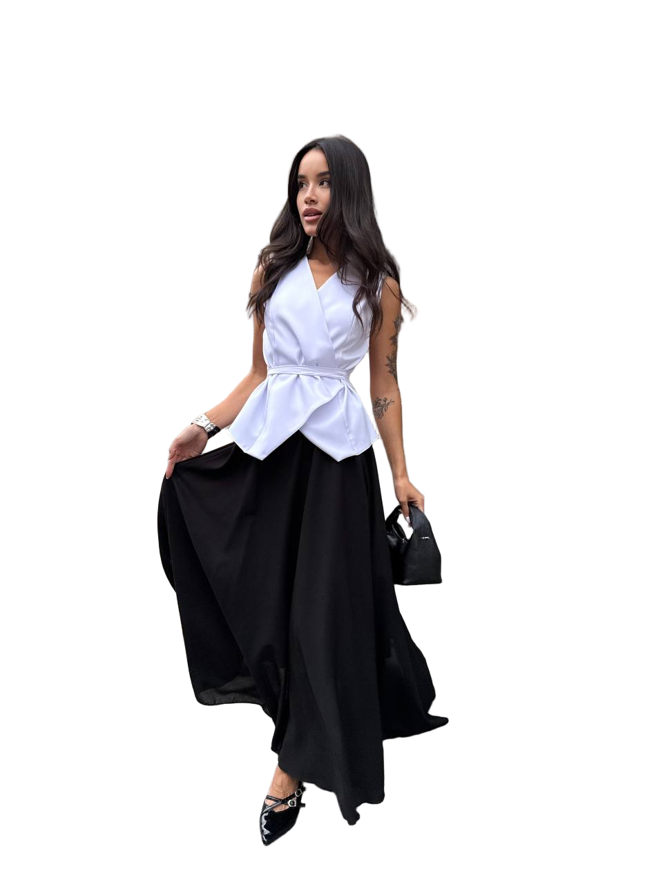 Woman wearing a white top and black skirt with a handbag on a white background