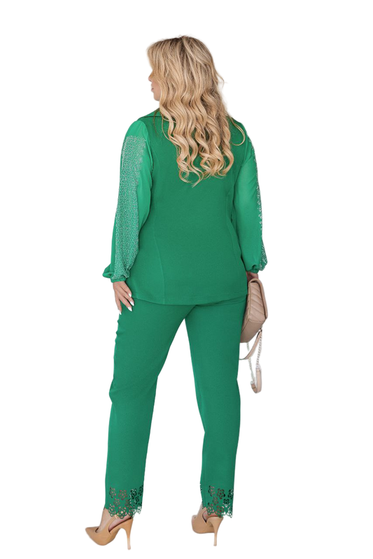 Woman wearing a green outfit with lace details on a white background