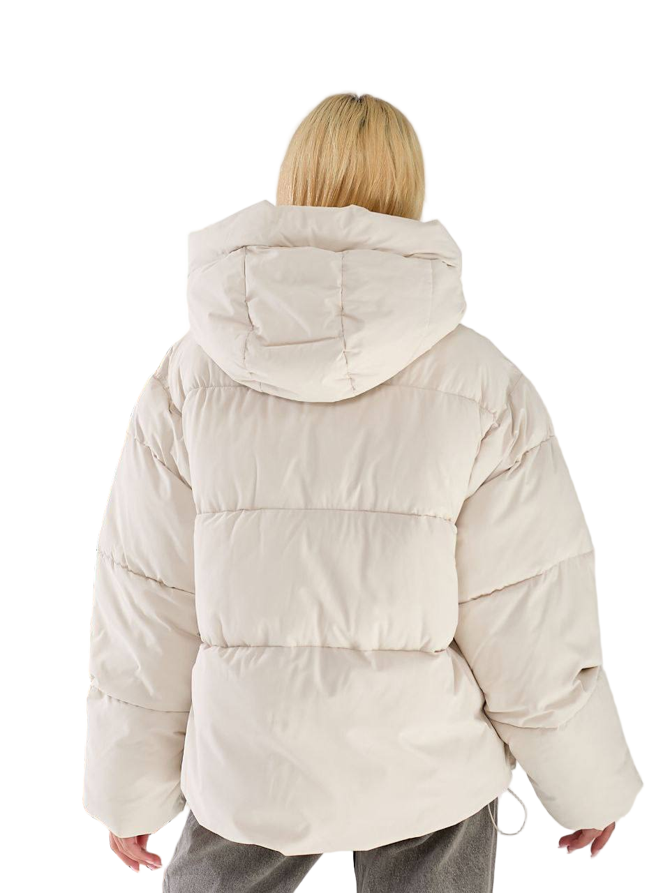 Person wearing a beige puffer jacket on a white background