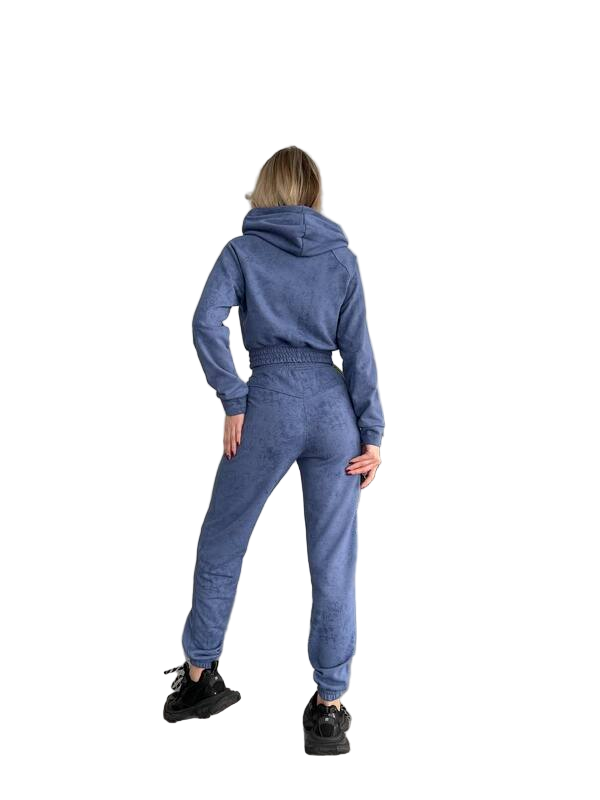 Person wearing a blue tracksuit on a white background