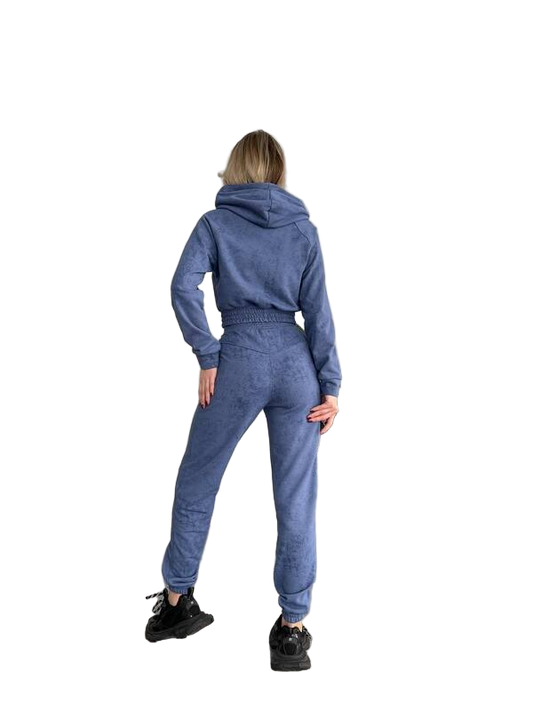 Person wearing a blue tracksuit on a white background