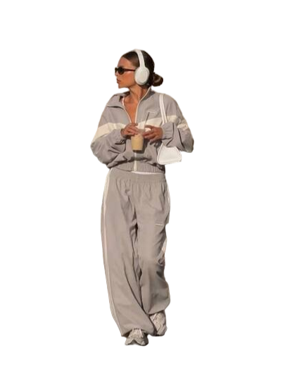 Person wearing a gray tracksuit with white stripes on a white background