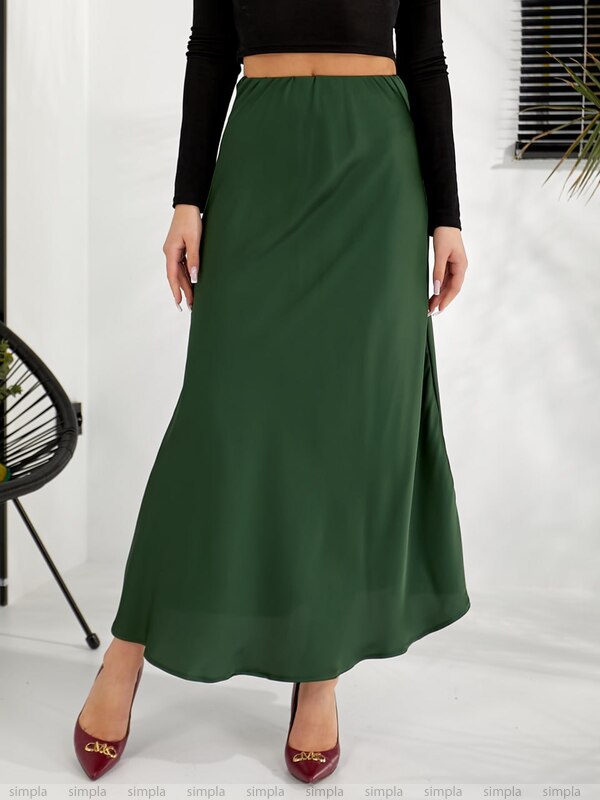 Green skirt worn by a person on a white background