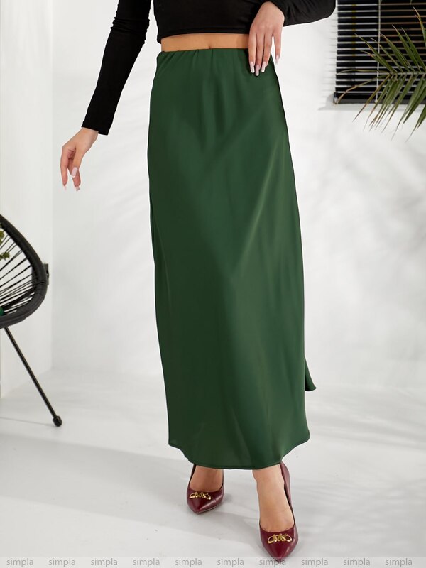 Person wearing a green skirt on a white background