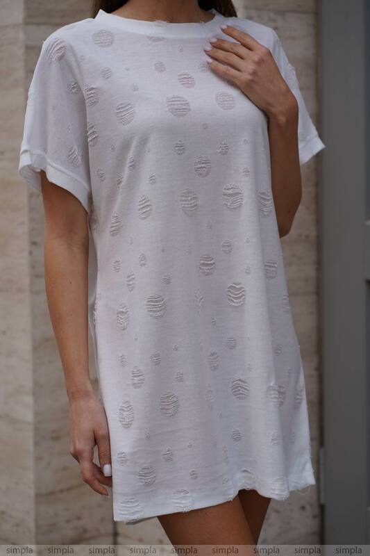 White t-shirt with subtle pattern worn by a person against a neutral background