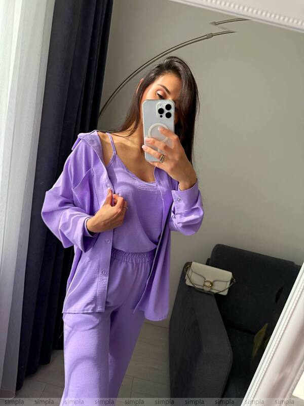 Person wearing a purple outfit taking a mirror selfie.