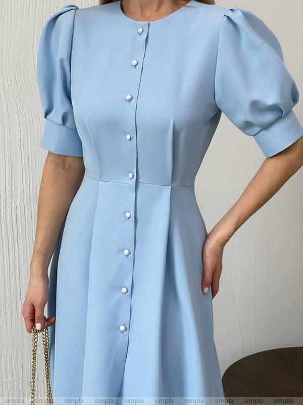 Light blue dress with puff sleeves on a neutral background