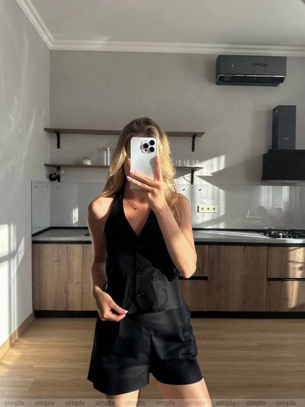 Person taking a mirror selfie in a modern kitchen