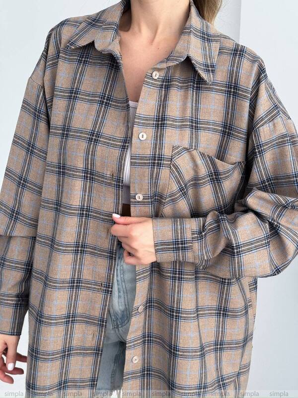 Plaid shirt worn by a person on a plain background