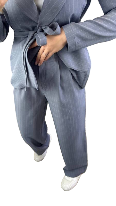 Person wearing a gray pinstripe suit with a white background