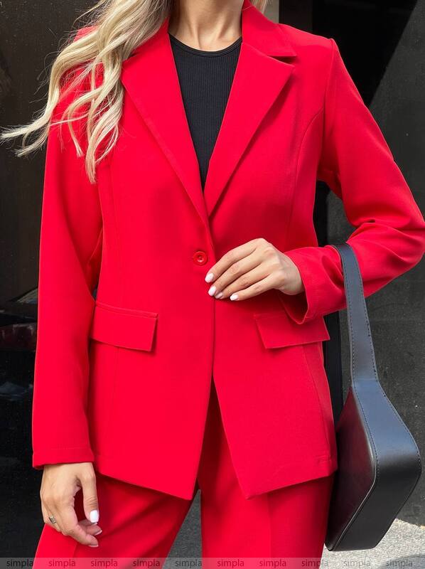 Person wearing a red suit with a black background