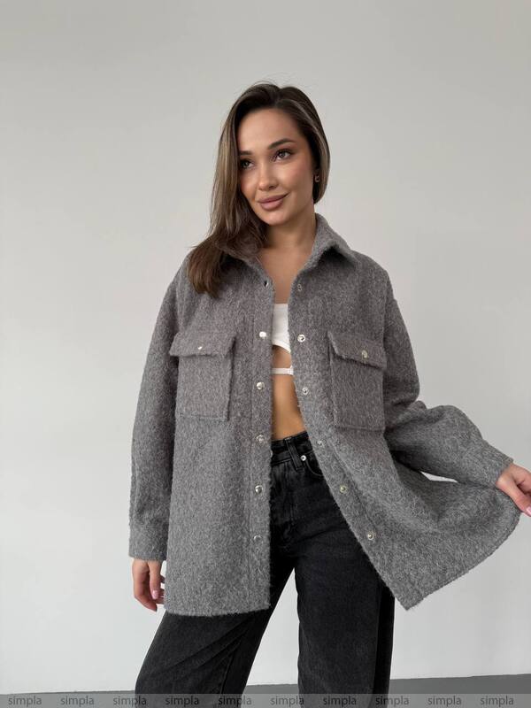 Woman wearing a gray coat on a plain background