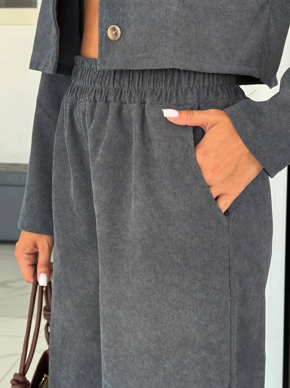 Person wearing gray pants with a blurred background