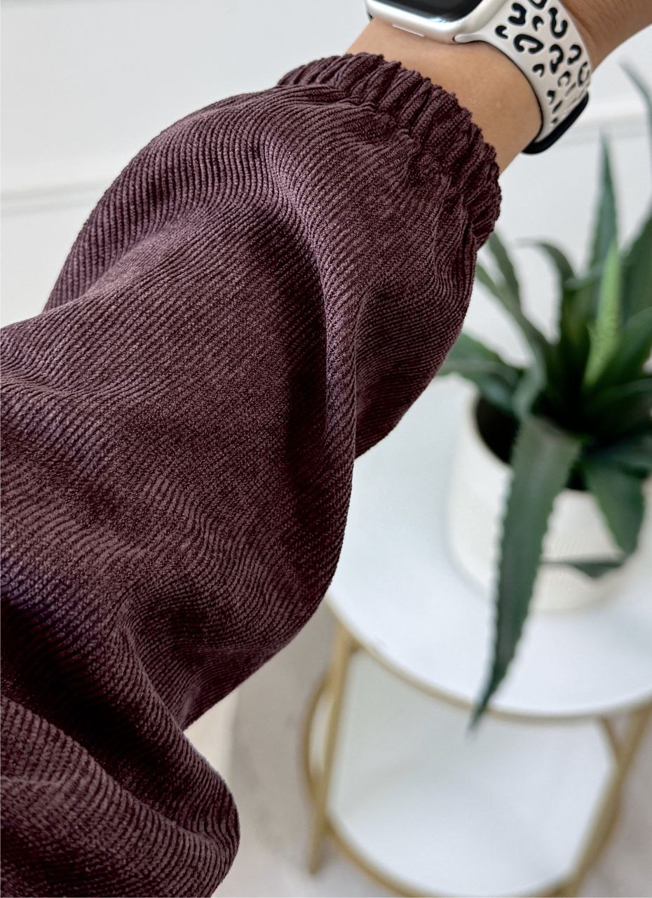 Brown knitted sweater with a blurred background