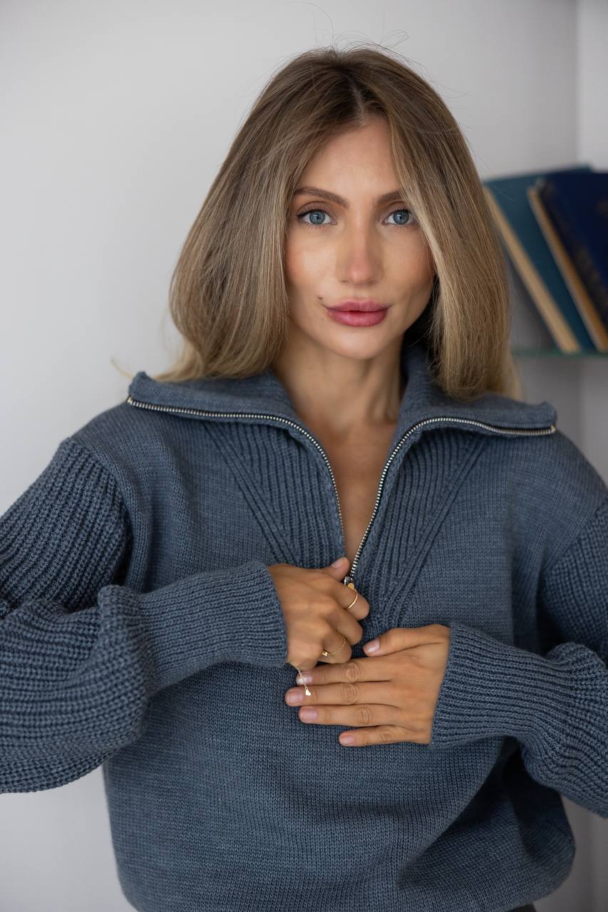 Woman wearing a blue sweater against a neutral background