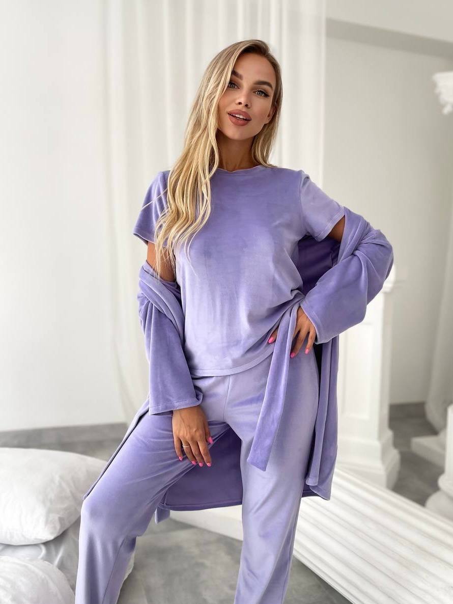 Woman wearing a lavender outfit in a bright room