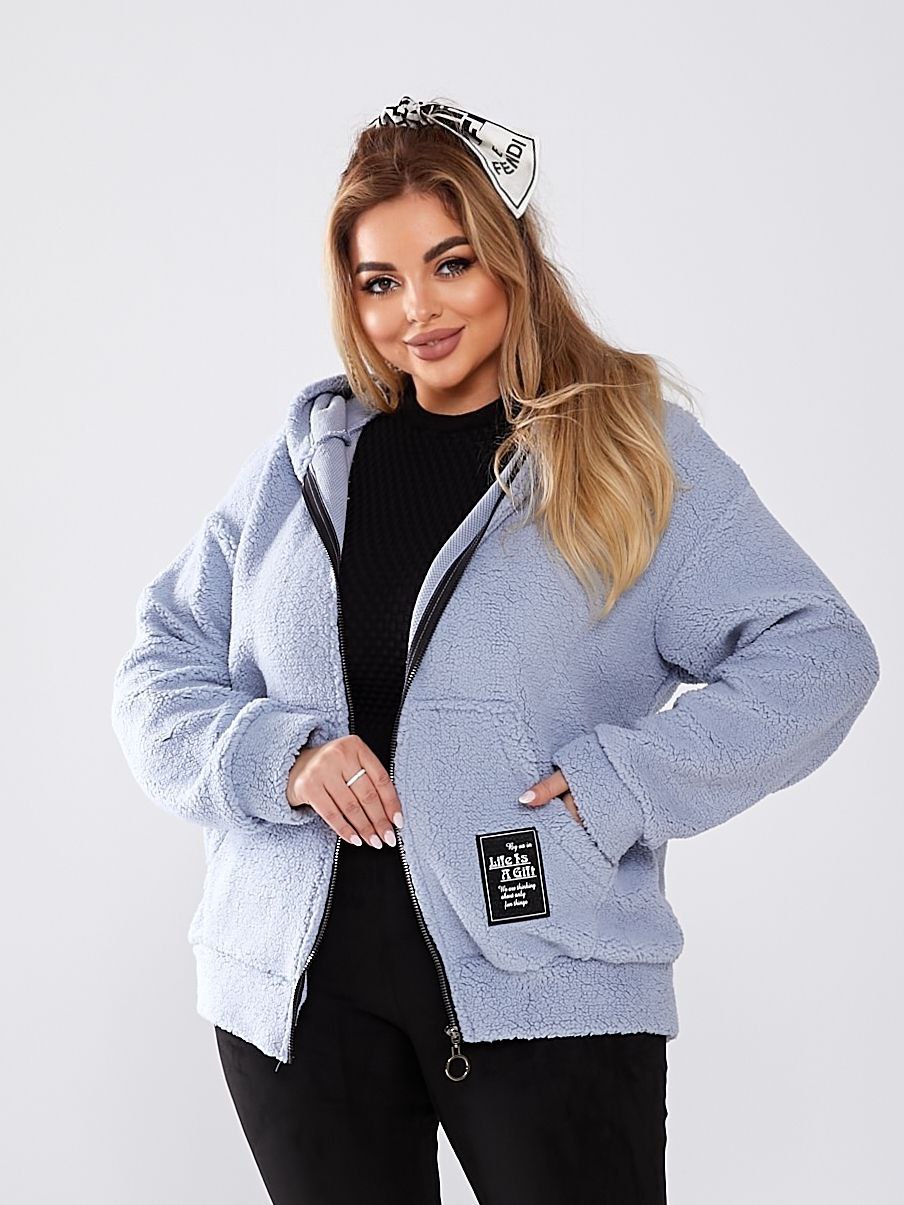 Woman wearing a light blue jacket with a brand logo on a white background