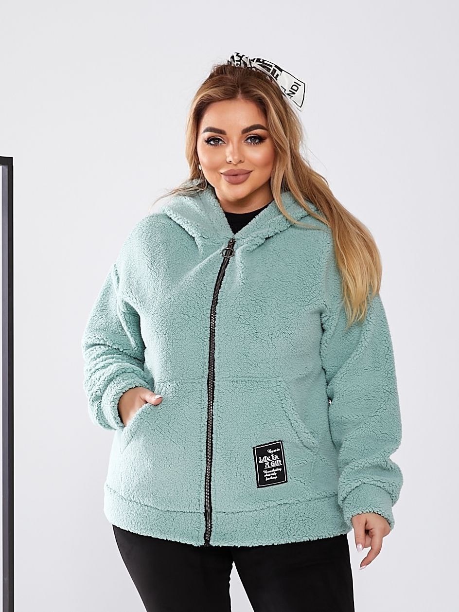 Woman wearing a light blue fleece jacket with a brand logo on a white background