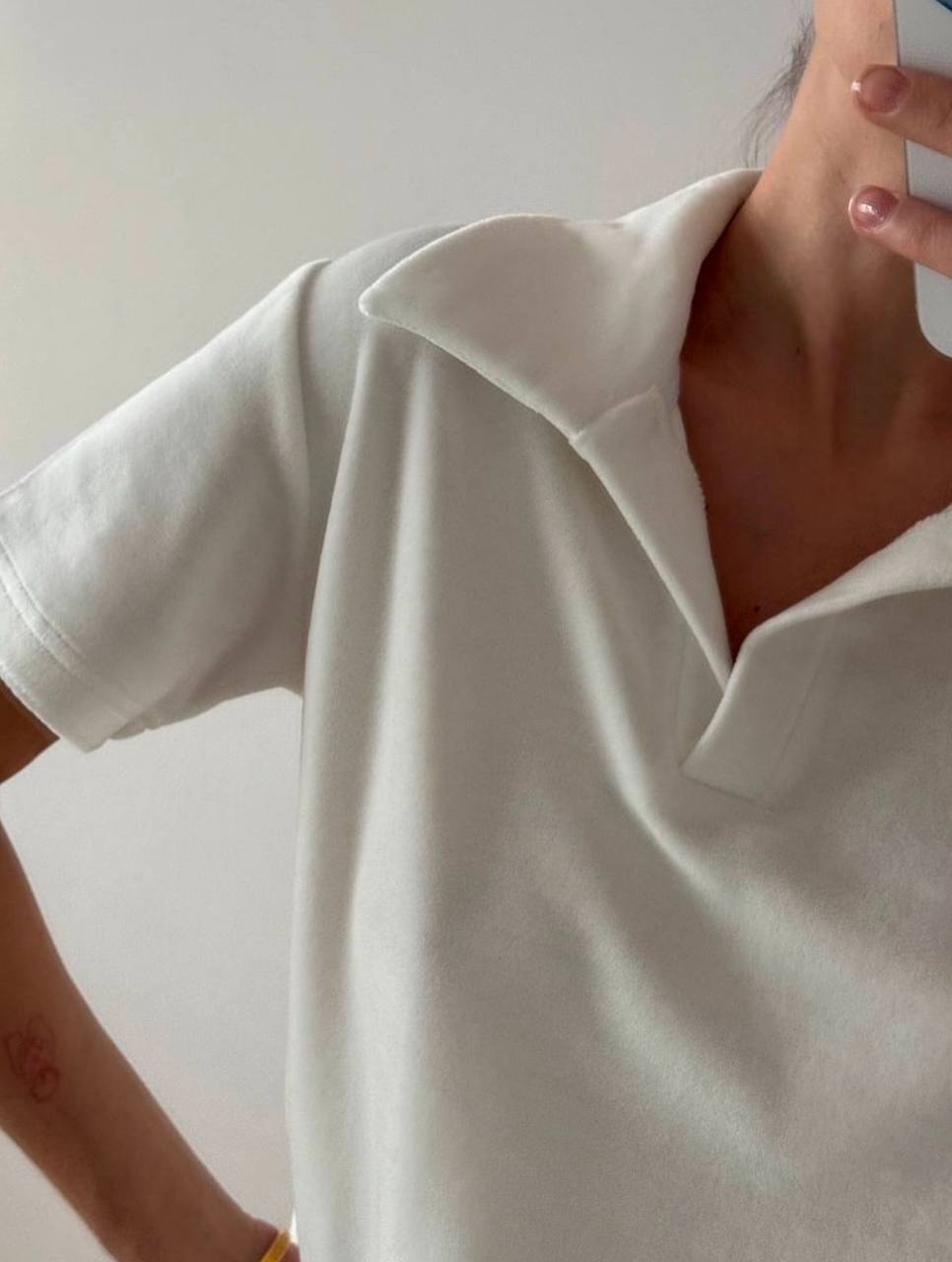 White t-shirt worn by a person with a neutral background