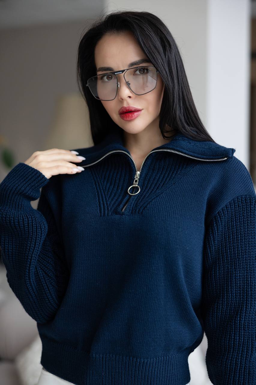 Woman wearing a dark blue sweater with a blurred background