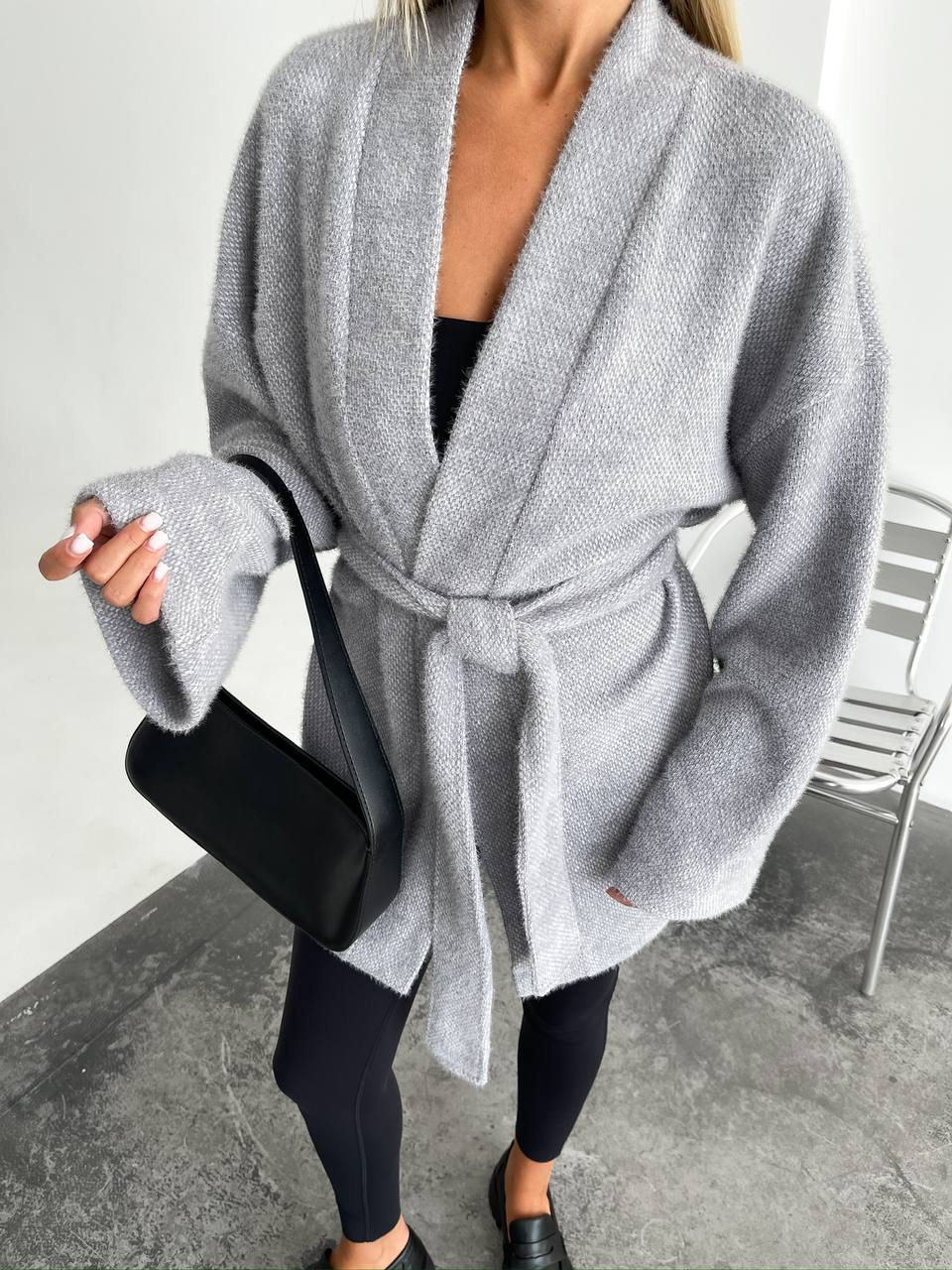 Person wearing a gray robe in an indoor setting