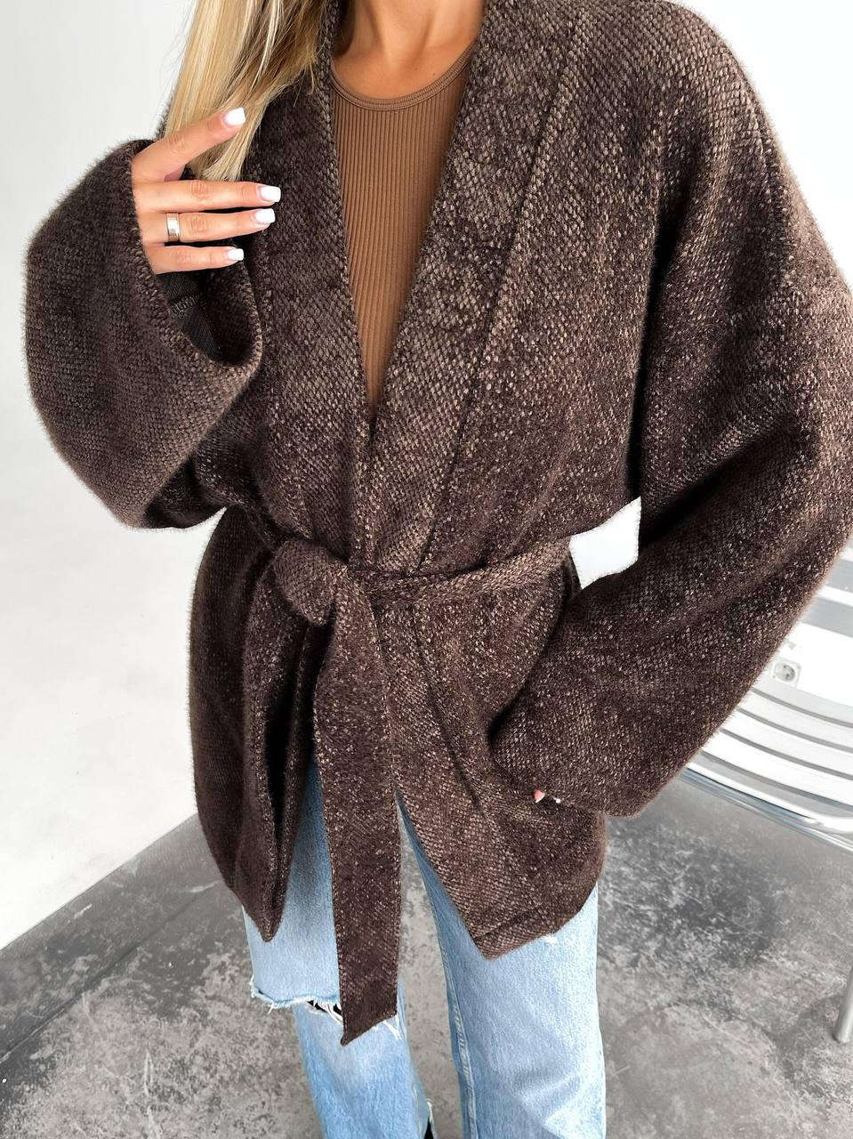 Brown belted cardigan worn by a person on a neutral background