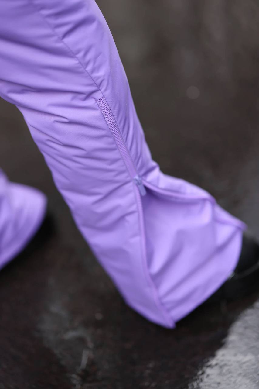 Purple rain boot on a dark surface