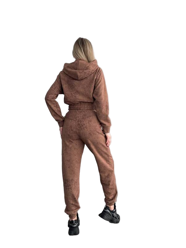 Person wearing a brown tracksuit from behind on a white background