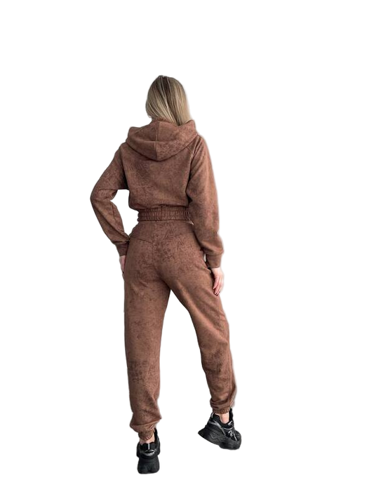 Person wearing a brown tracksuit from behind on a white background