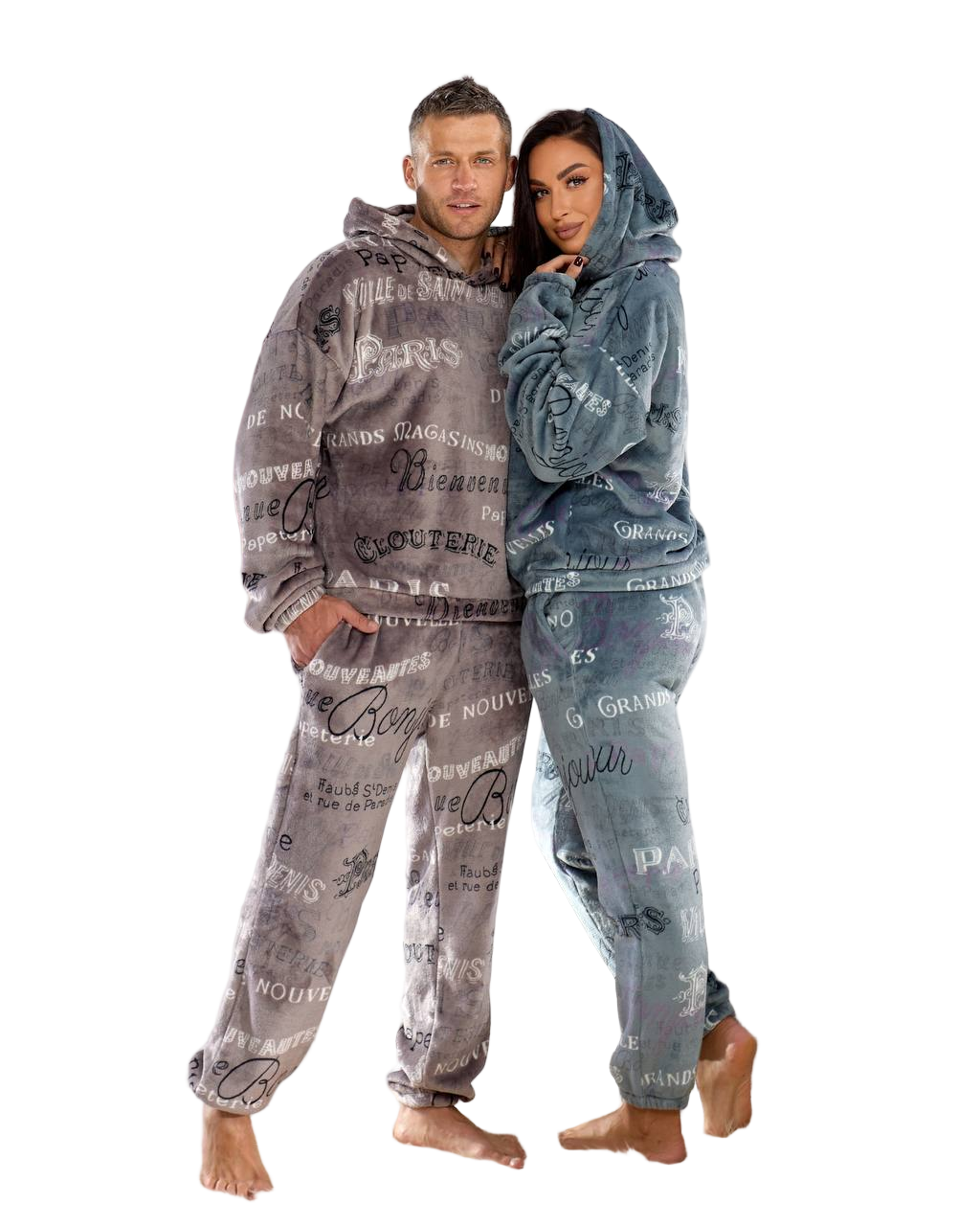 Two people wearing matching gray hoodies and pants with text design on a white background