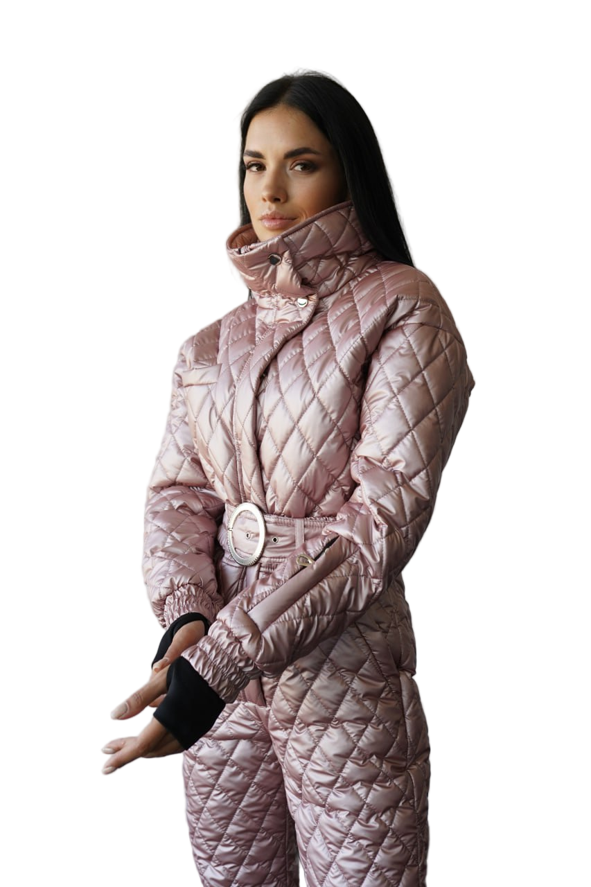 Person wearing a quilted pink snowsuit on a white background
