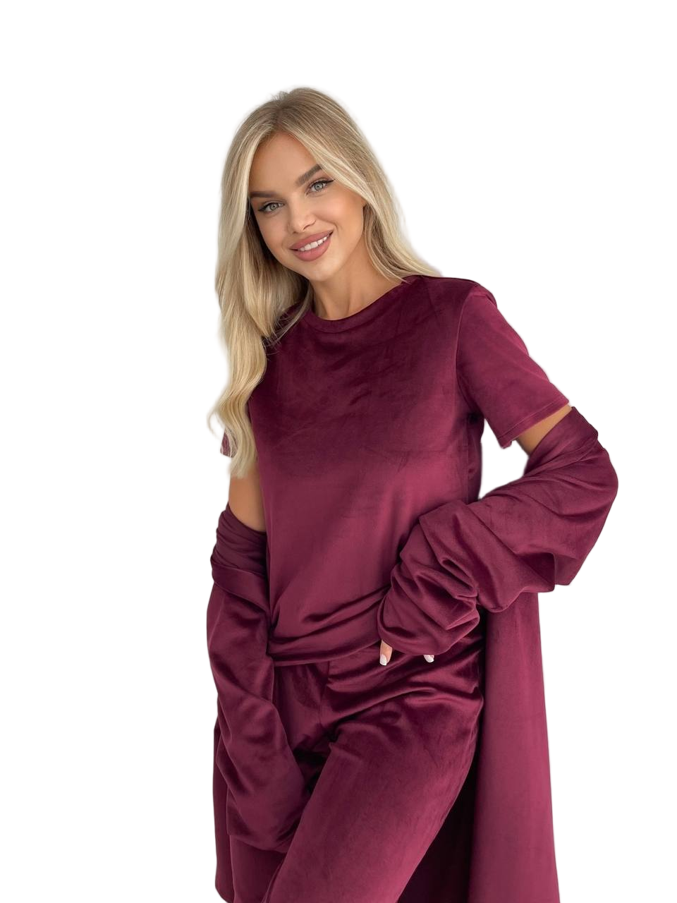Woman wearing a burgundy outfit with cut-out sleeves on a white background