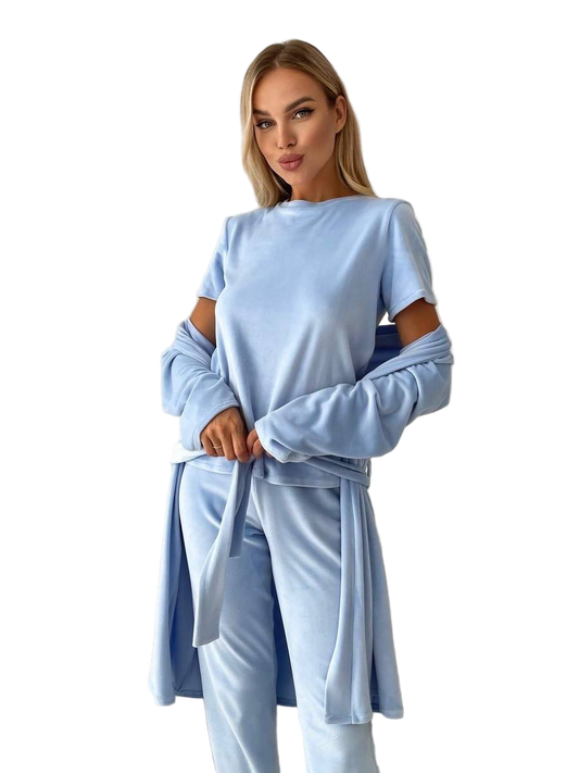 Woman wearing a light blue outfit with a matching jacket on a white background