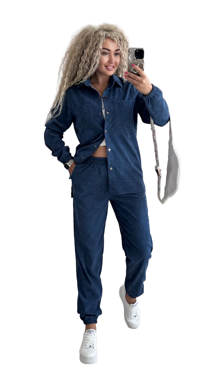 Woman taking a selfie wearing a blue tracksuit on a white background